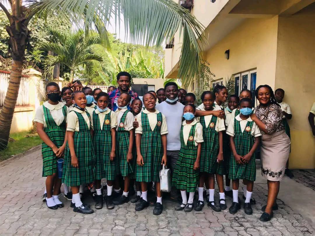 Mena College students in green tartan uniforms on campus